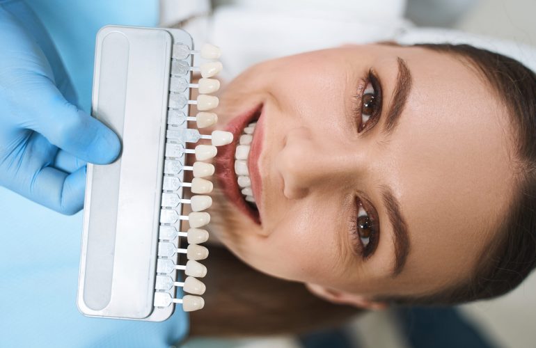 Happy young lady is visiting dental clinic for taking care of teeth and getting better smile